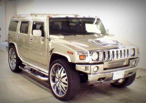 Hummer H2 luxury SUV with custom large wheels and chrome accents.