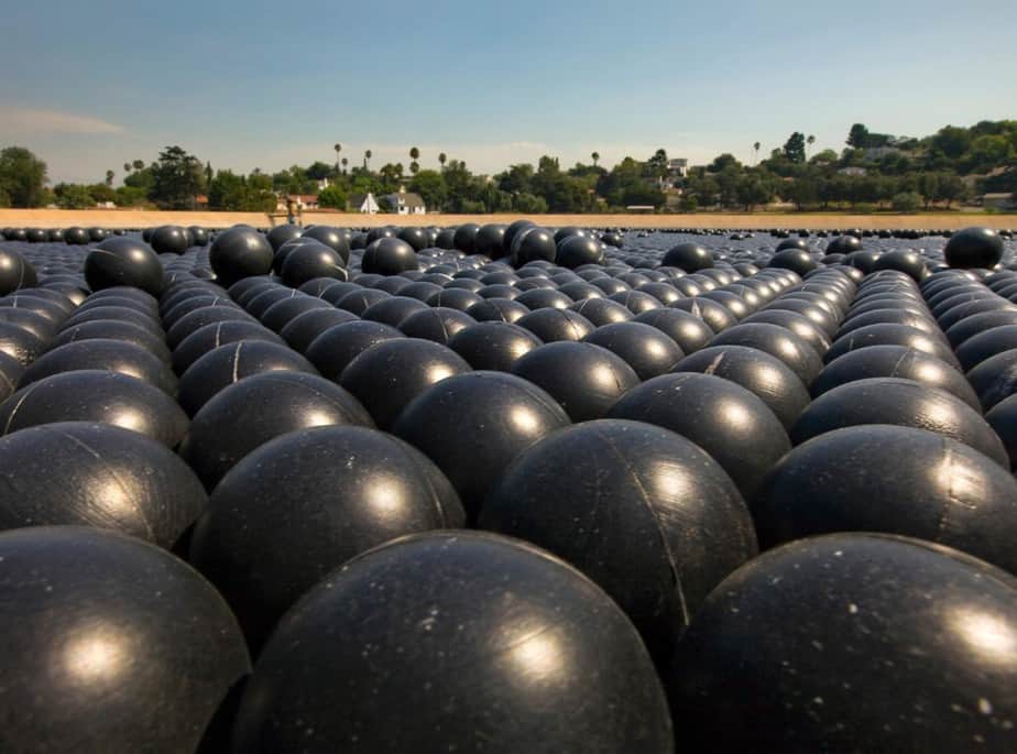 Large black water storage tanks for evaporation and water treatment.